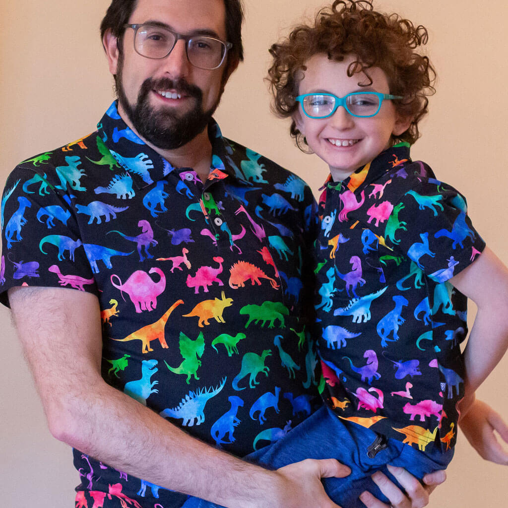 "Prehistoric Parade" Rainbow of Dinosaurs Short Sleeve Polo Shirt